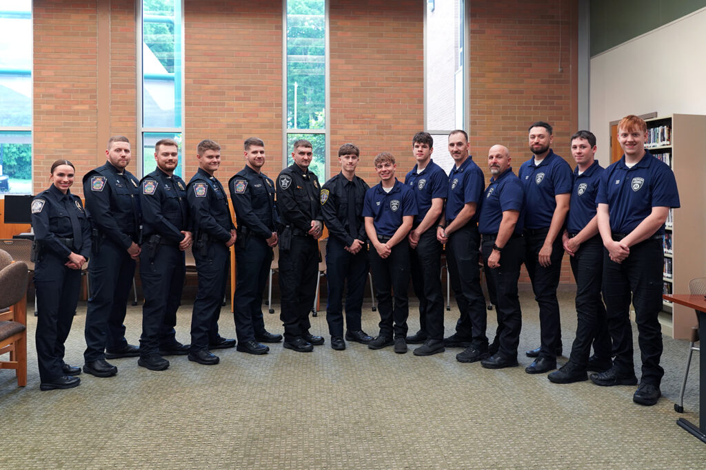 Cadet Class No. 92 standing in library before ceremony smiling.