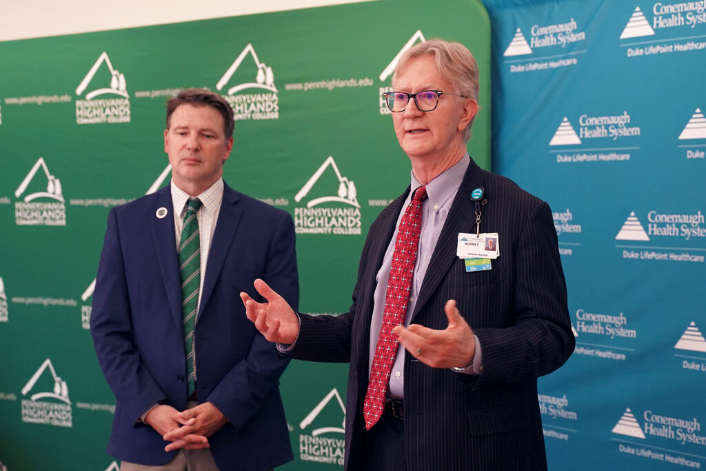 Dr. Steve Nunez (left), President of Penn Highlands Community College, shaking hands with Dr. Rodney Reider (right), CEO of Conemaugh Memorial Medical Center, after signing the Surgical Technology partnership documentation.