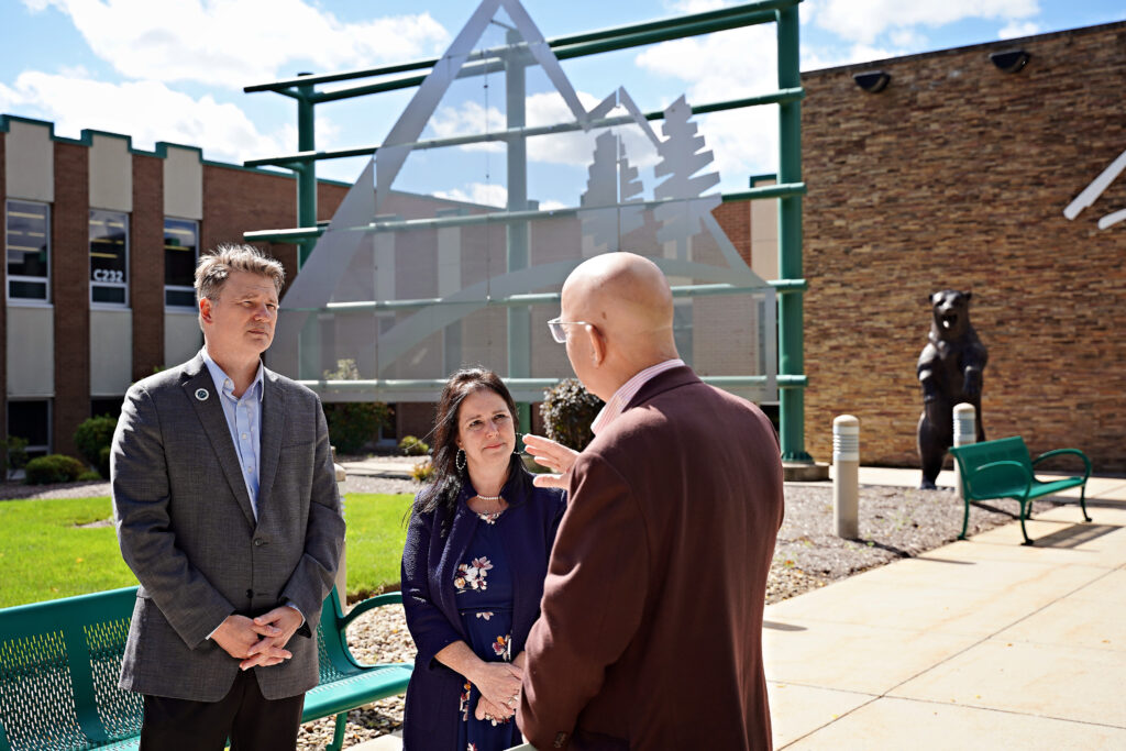 Dr. Steve Nunez, President of the College, Carole Van Meter, Director of the College Foundation, and Mike Kane, President of the Community Foundation for the Alleghenies, conversing outside of the College’s Richland Campus.